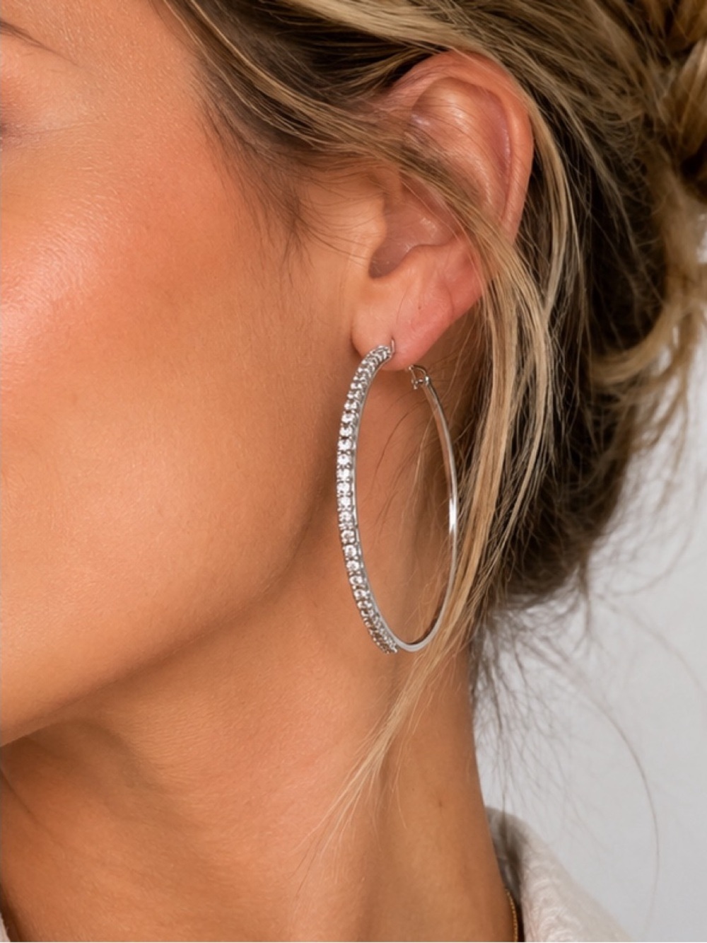 Medium sized silver-toned circular hoops lined with rhinestones